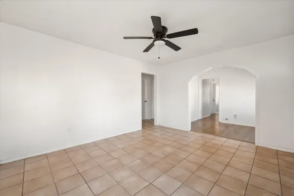 a view of a big room with closet and ceiling fan
