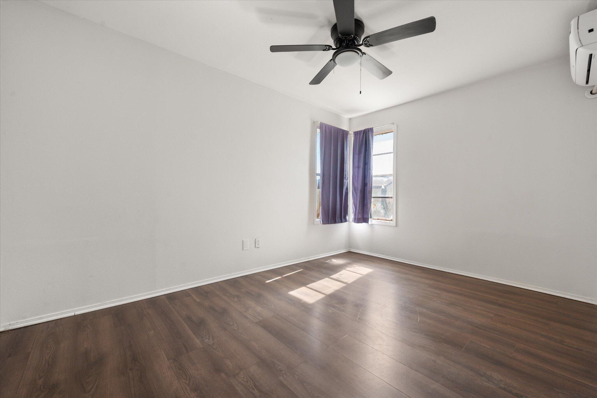 1303 28th Street Lubbock, TX 79411 - Photo 8 of 12 wooden floor in an empty room