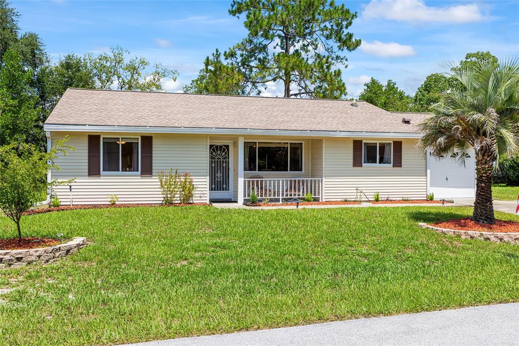 10888 Southwest 90th Court Ocala, FL 34481 - Photo 1 of 37 a front view of house with yard and green space