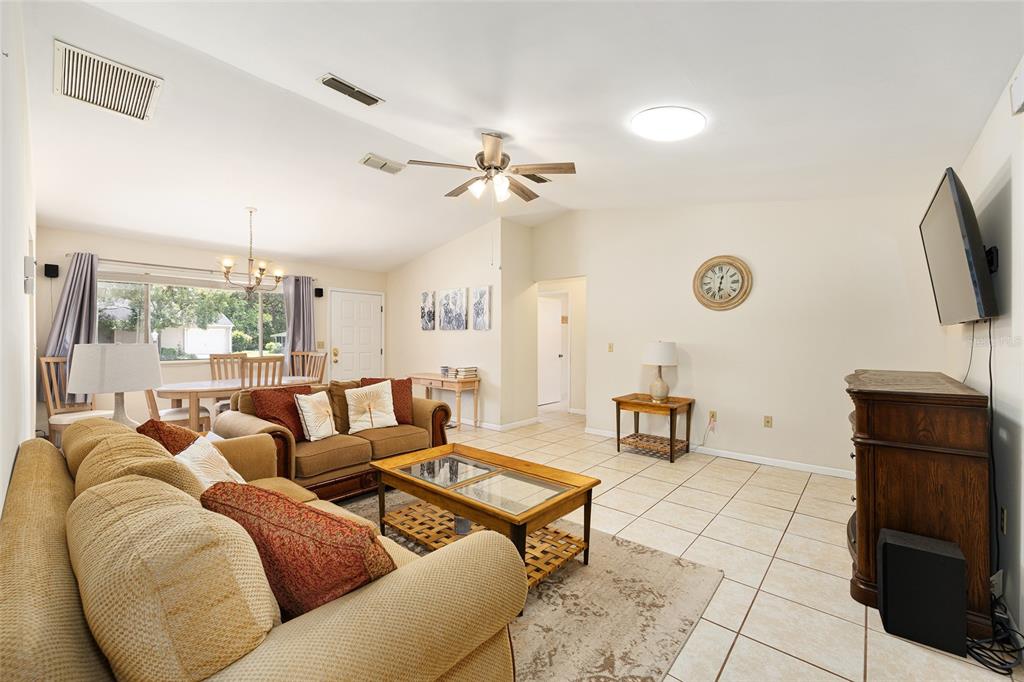 10888 Southwest 90th Court Ocala, FL 34481 - Photo 13 of 37 a living room with furniture a table and a flat screen tv