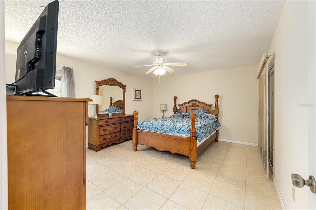 10888 Southwest 90th Court Ocala, FL 34481 - Photo 24 of 37 a bed room with a bed and a television
