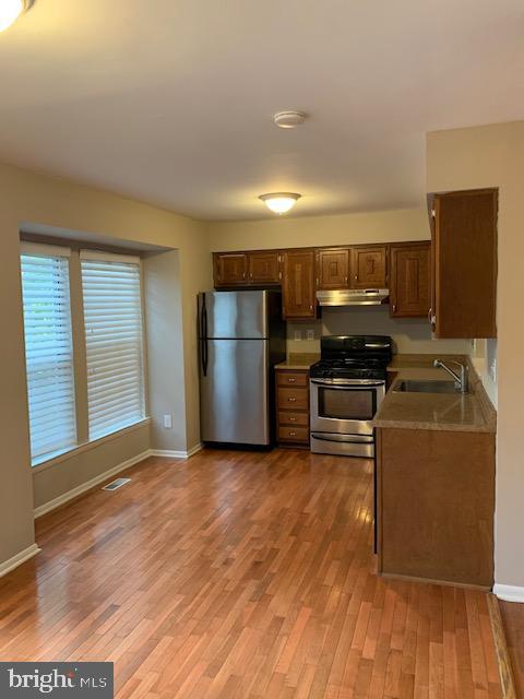 16 Cinzano Court Gaithersburg, MD 20878 - Photo 6 of 22 a kitchen with kitchen island wooden floors appliances and cabinets