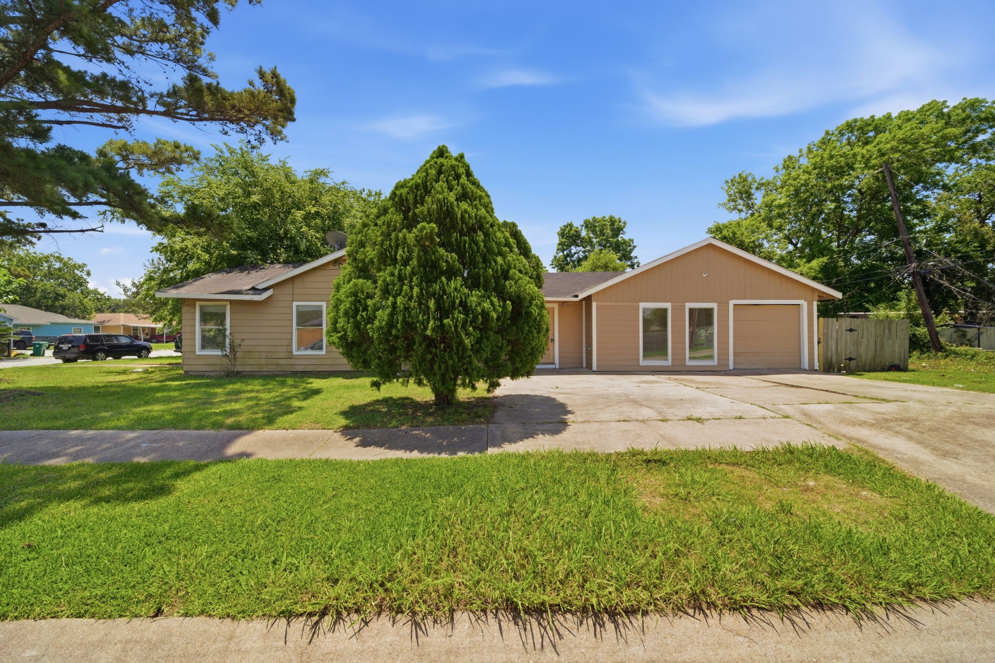 1102 Johnson Street Pasadena, TX 77506 - Photo 2 of 15 a yellow and red house with a garden