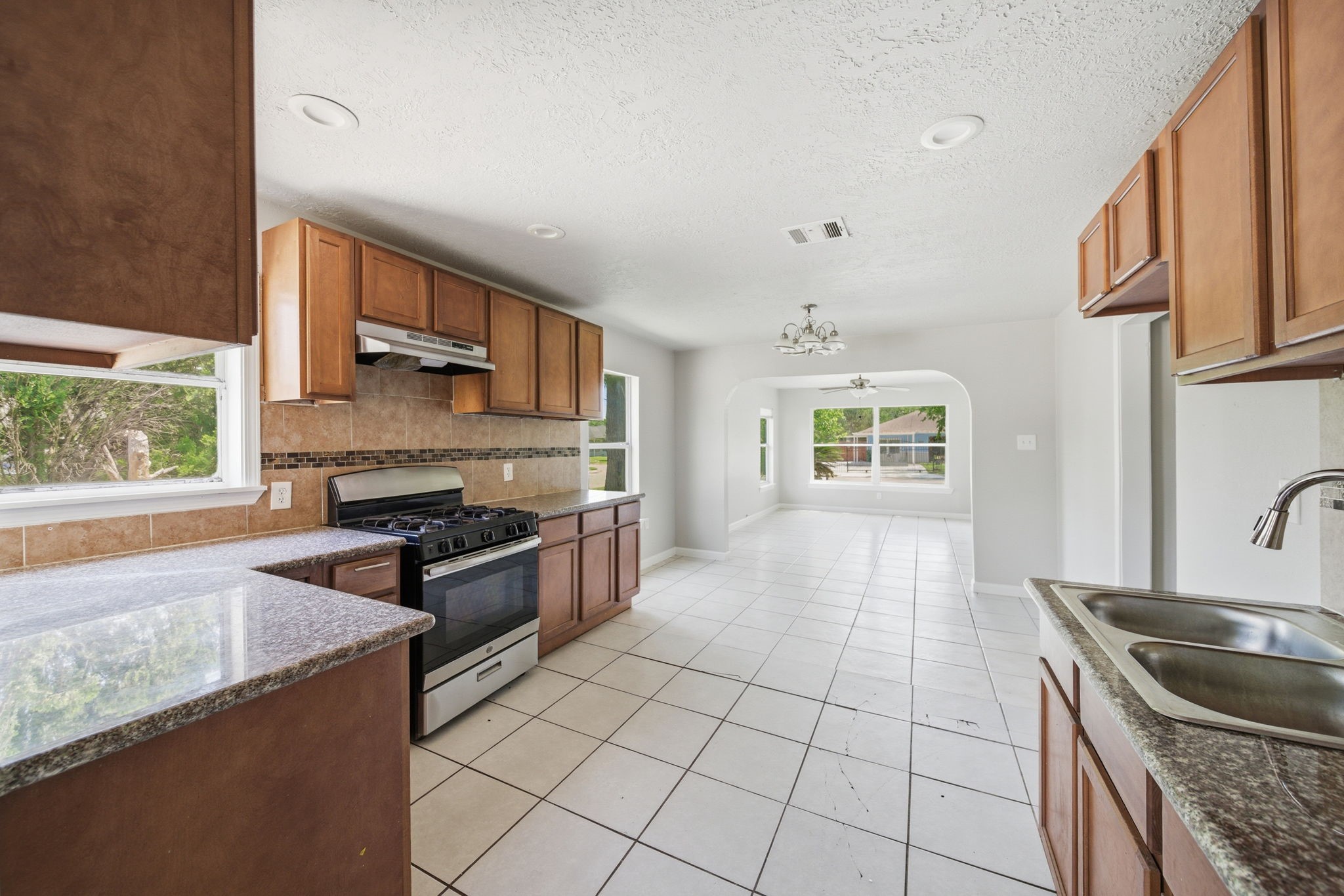 1102 Johnson Street Pasadena, TX 77506 - Photo 4 of 15 a kitchen with stainless steel appliances granite countertop a sink stove and cabinets