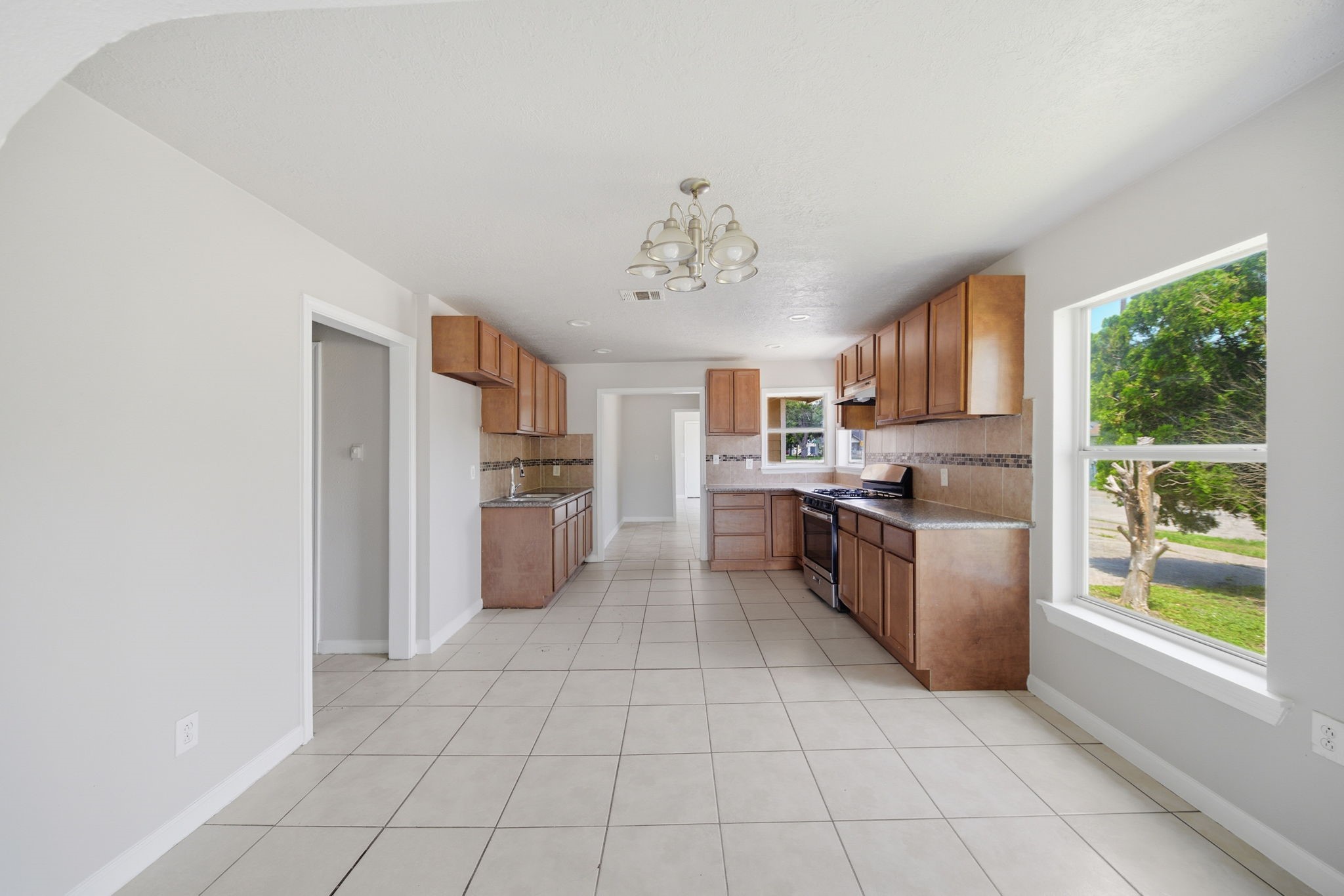 1102 Johnson Street Pasadena, TX 77506 - Photo 5 of 15 a kitchen with stainless steel appliances a refrigerator sink and microwave