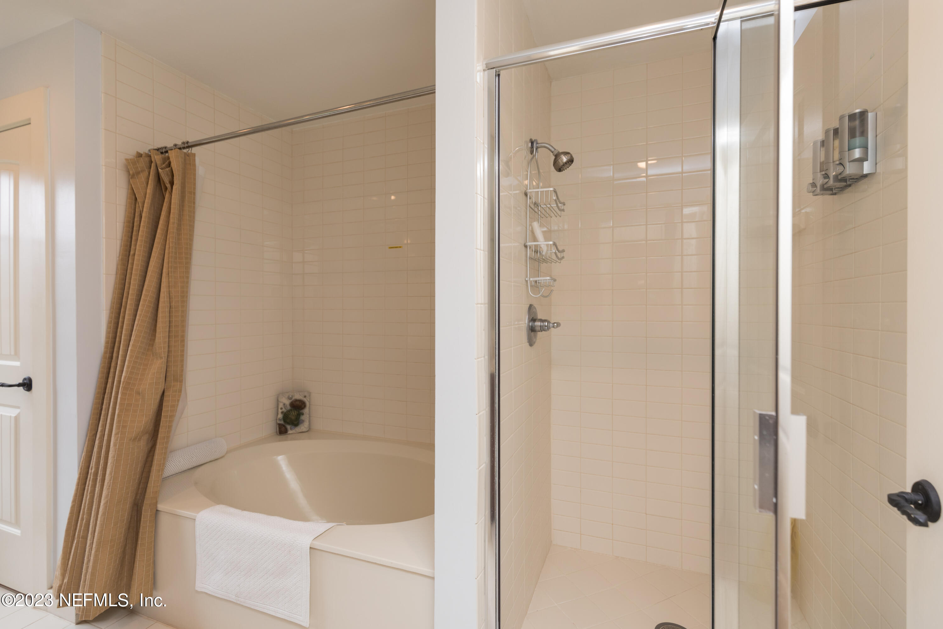945 Registry Boulevard, Unit 201 St. Augustine, FL 32092 - Photo 10 of 65 a bathroom with a bathtub and a shower