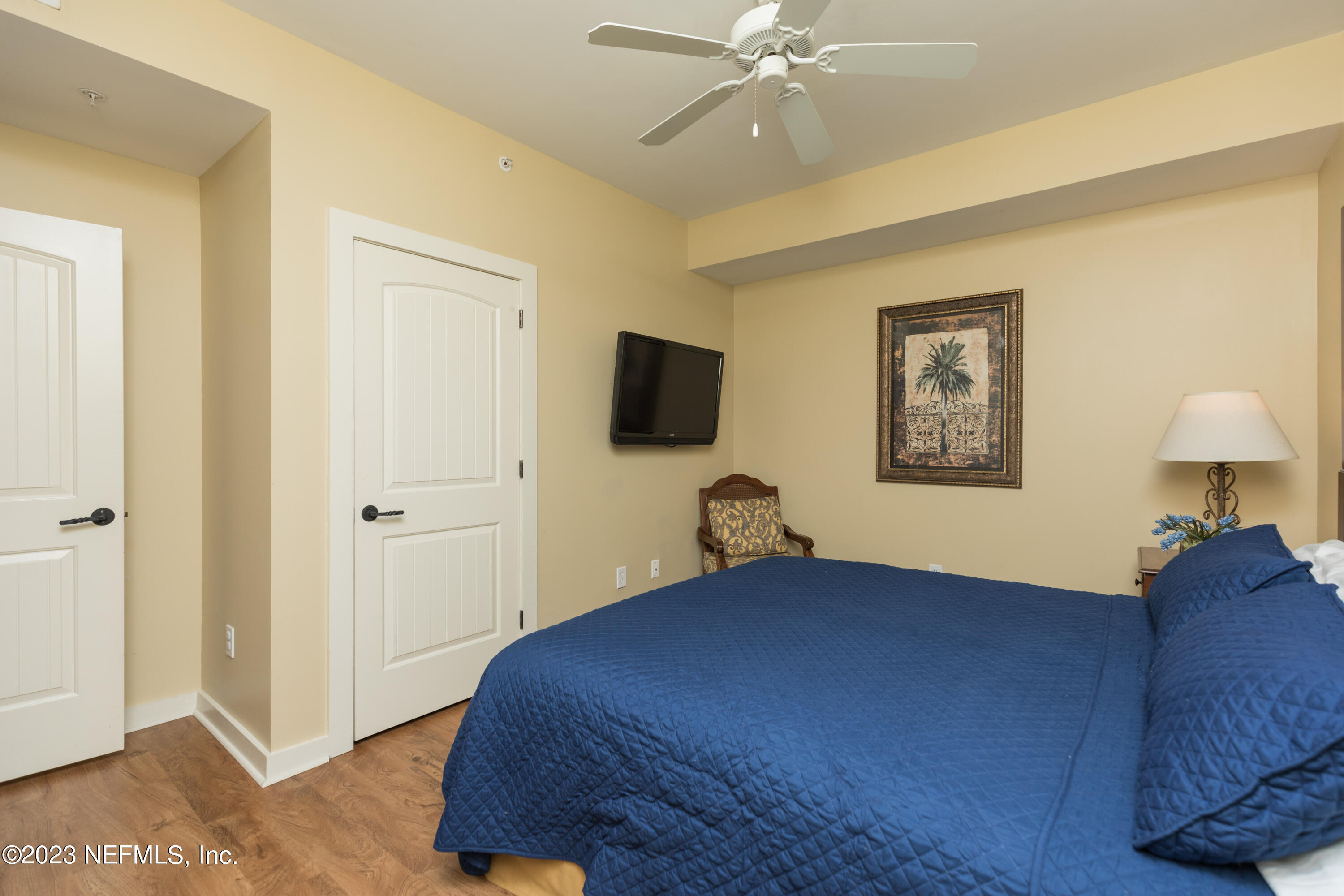 945 Registry Boulevard, Unit 201 St. Augustine, FL 32092 - Photo 11 of 65 a bedroom with a bed and a chandelier