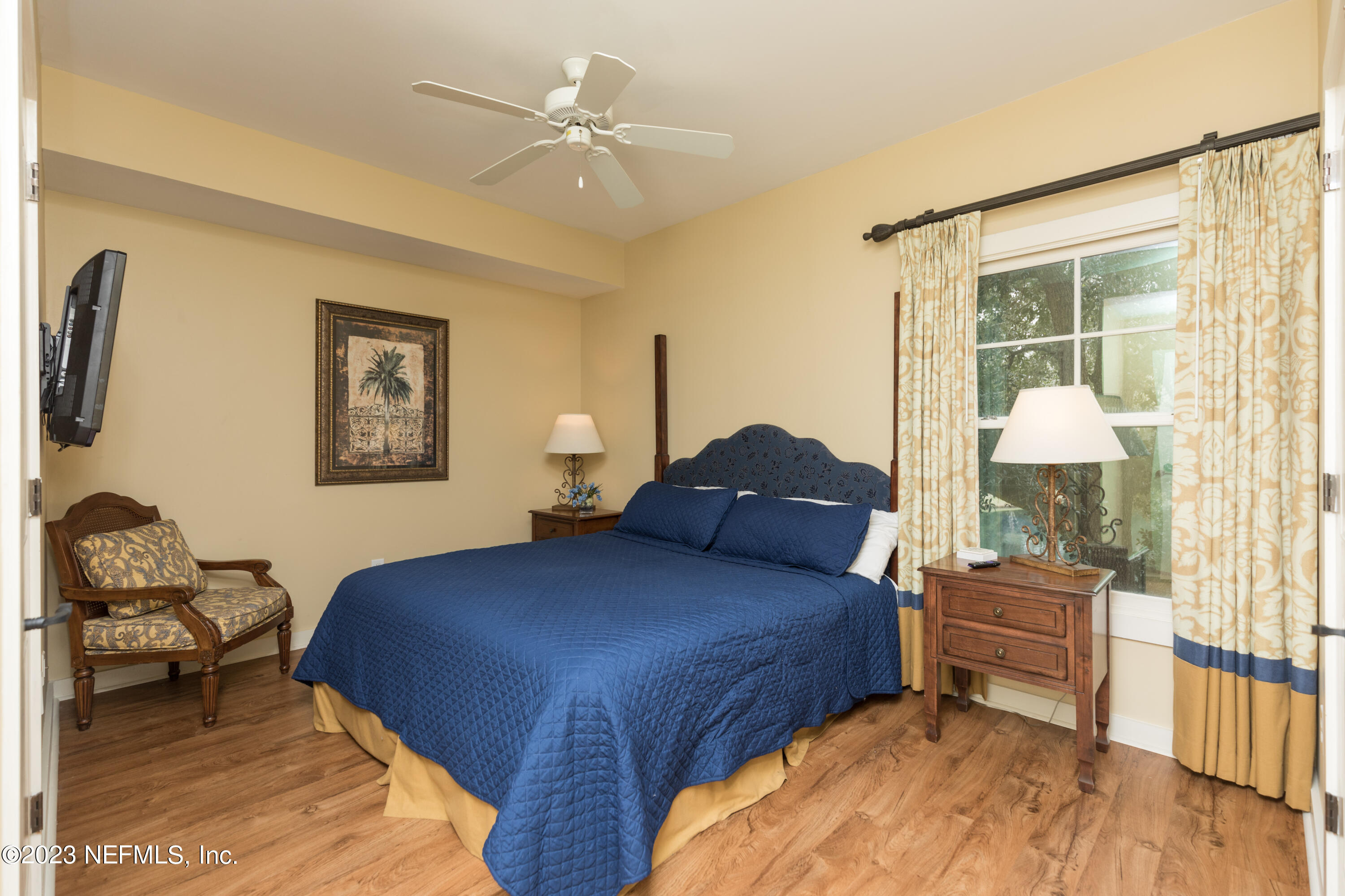 945 Registry Boulevard, Unit 201 St. Augustine, FL 32092 - Photo 12 of 65 a bedroom with a bed and wooden floor