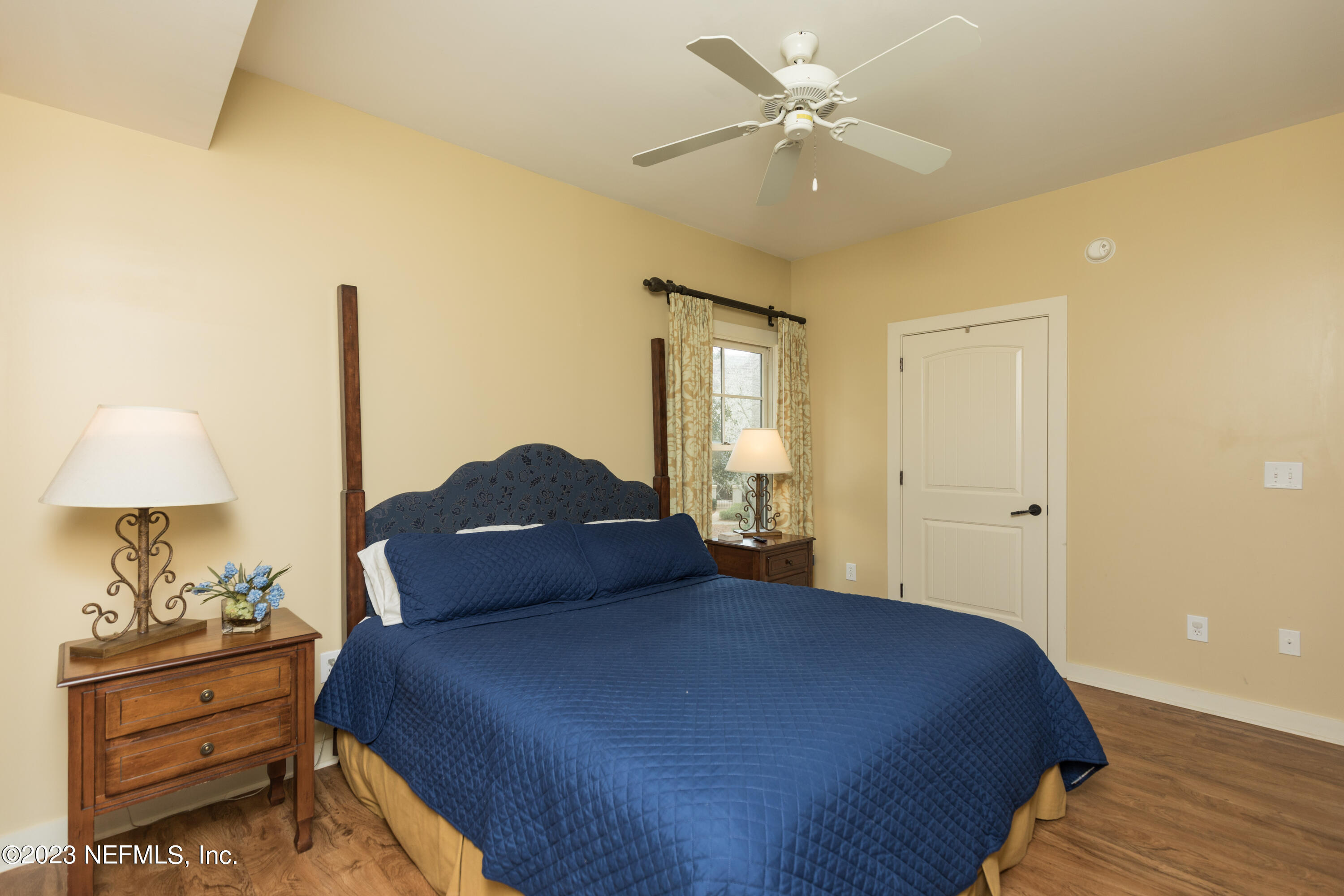 945 Registry Boulevard, Unit 201 St. Augustine, FL 32092 - Photo 13 of 65 a bedroom with a bed and a chandelier