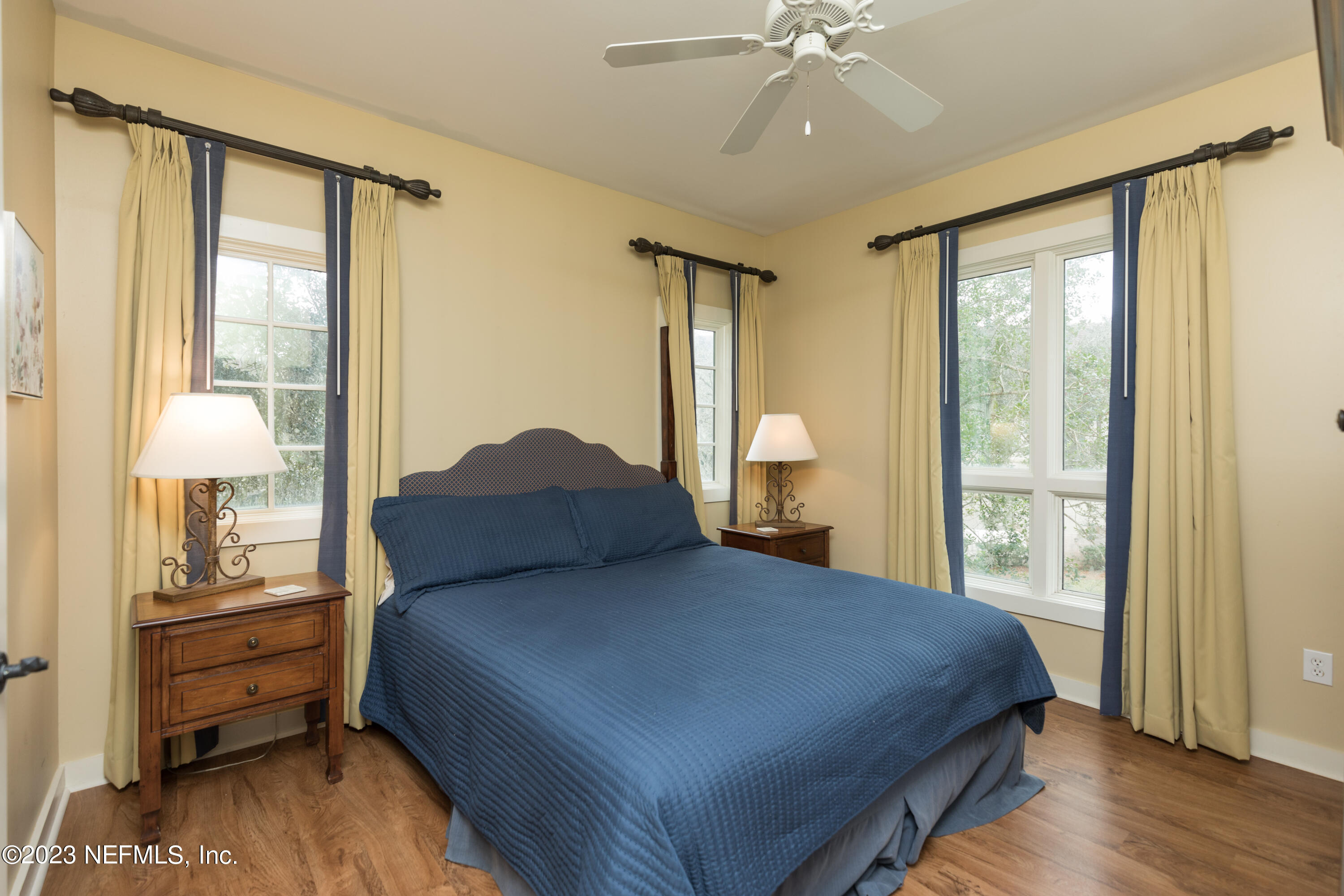 945 Registry Boulevard, Unit 201 St. Augustine, FL 32092 - Photo 18 of 65 a bedroom with a large bed and a chandelier fan