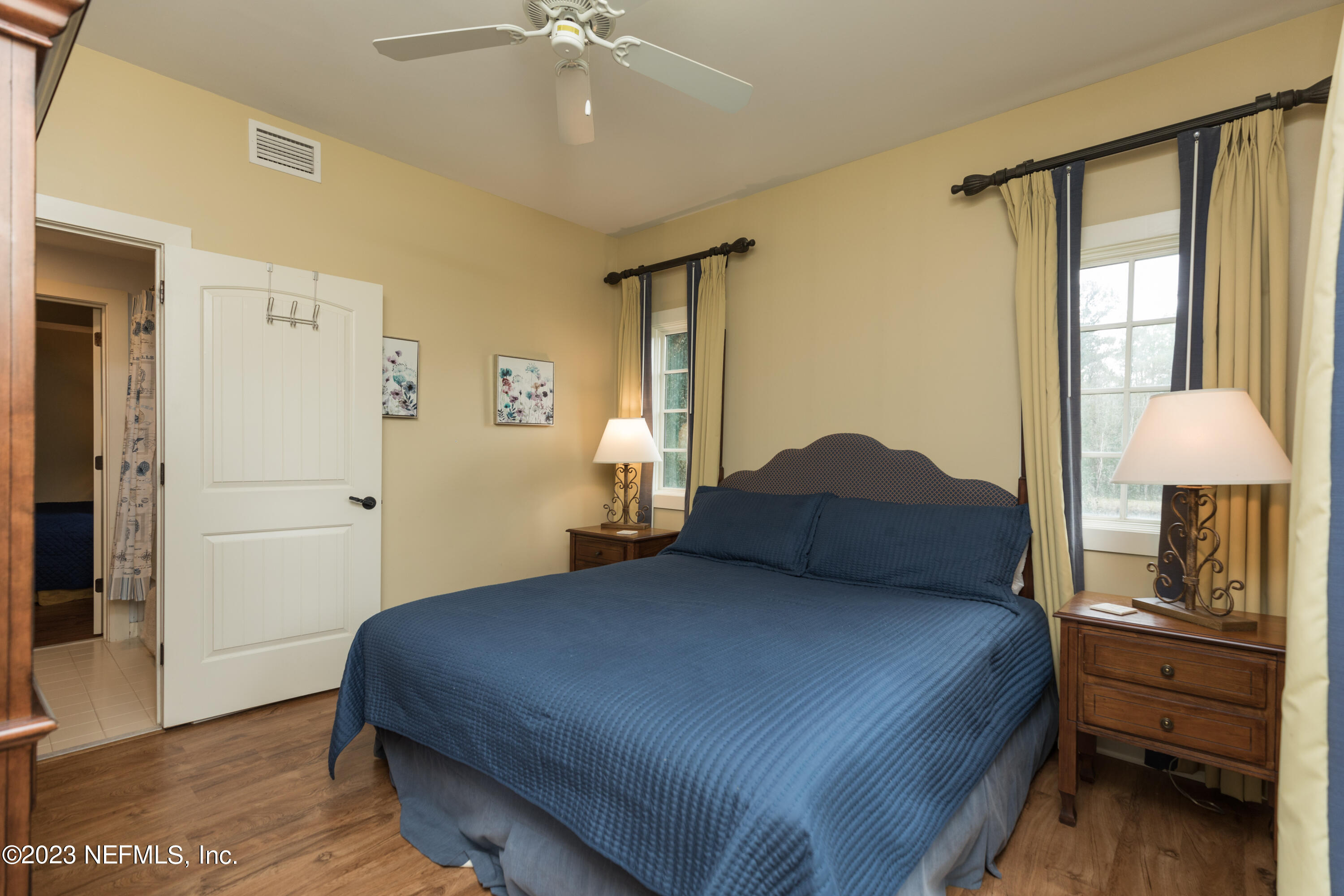 945 Registry Boulevard, Unit 201 St. Augustine, FL 32092 - Photo 19 of 65 a bedroom with a bed and wooden floor