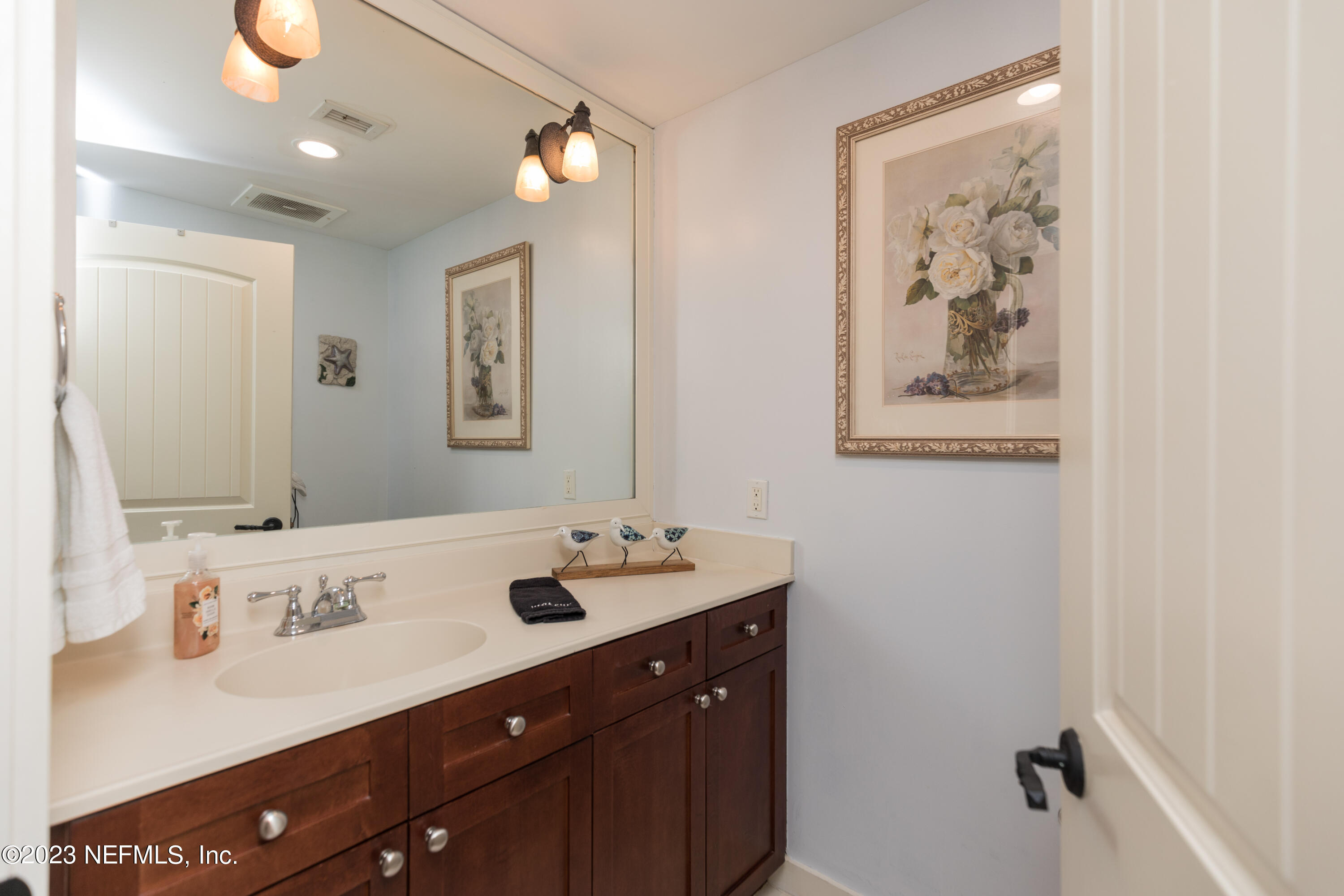 945 Registry Boulevard, Unit 201 St. Augustine, FL 32092 - Photo 22 of 65 a bathroom with a double vanity sink and a mirror