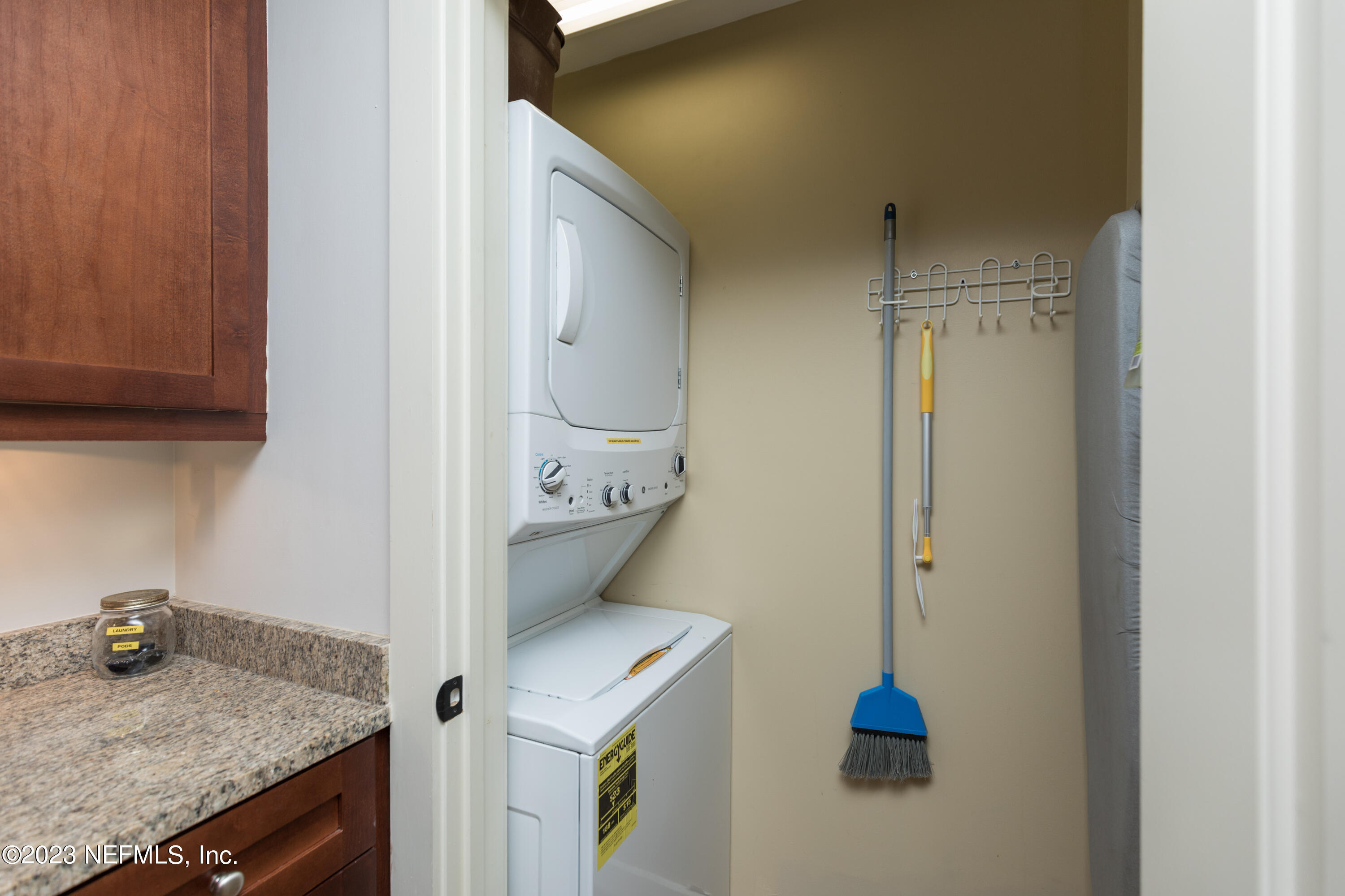 945 Registry Boulevard, Unit 201 St. Augustine, FL 32092 - Photo 23 of 65 a kitchen with a granite countertop sink and cabinets