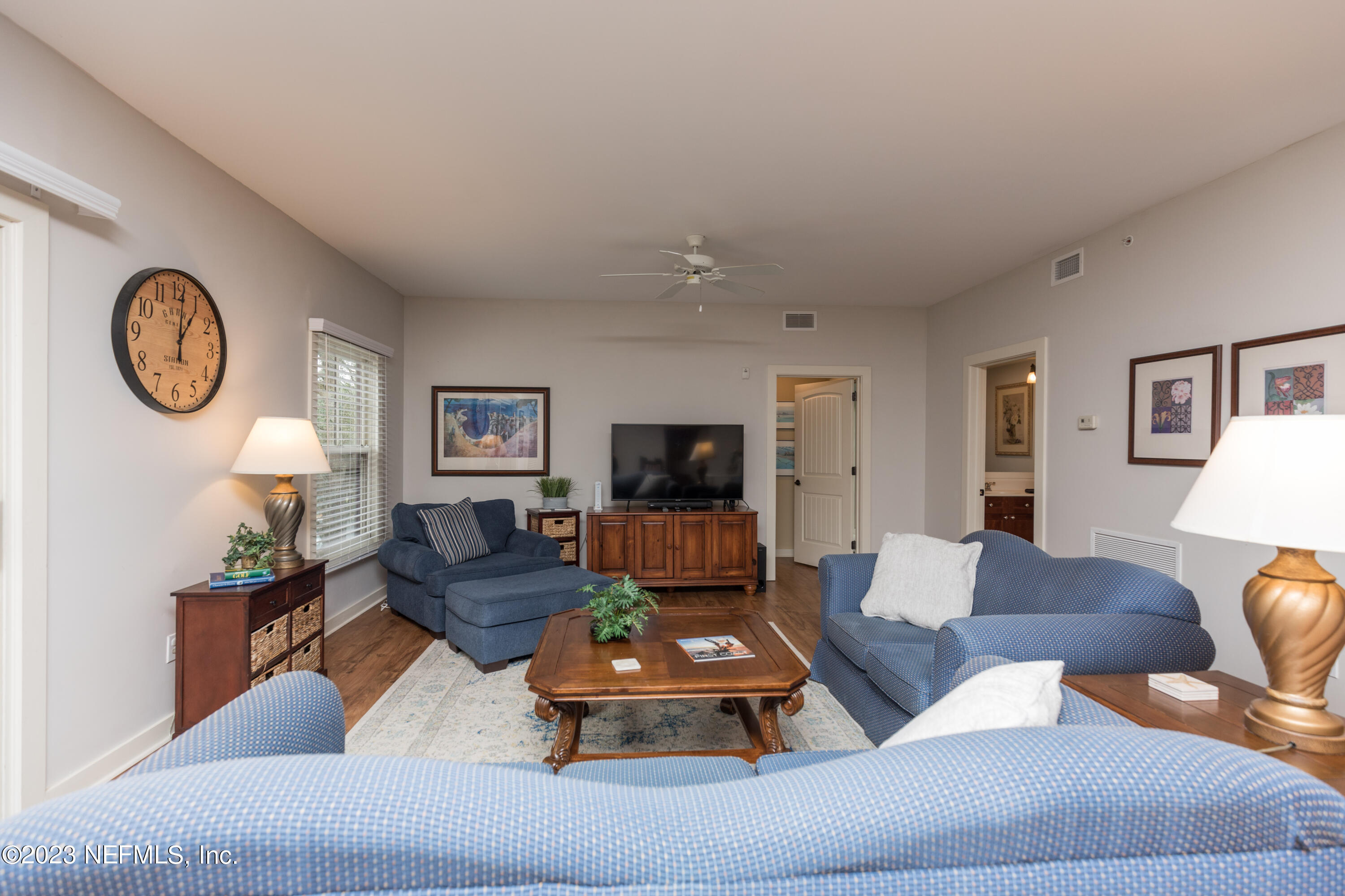945 Registry Boulevard, Unit 201 St. Augustine, FL 32092 - Photo 25 of 65 a living room with furniture and a flat screen tv