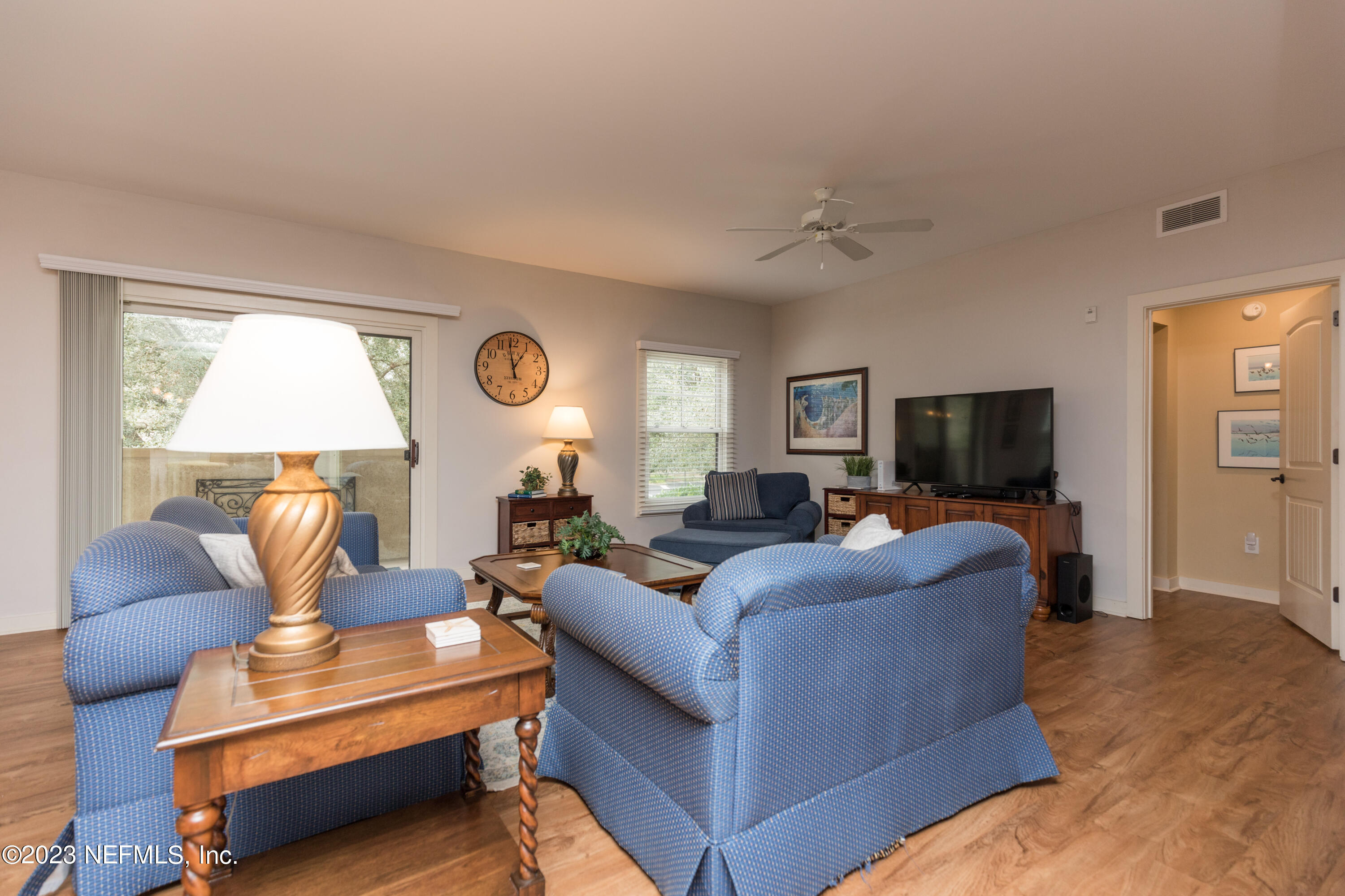 945 Registry Boulevard, Unit 201 St. Augustine, FL 32092 - Photo 26 of 65 a living room with furniture and a flat screen tv