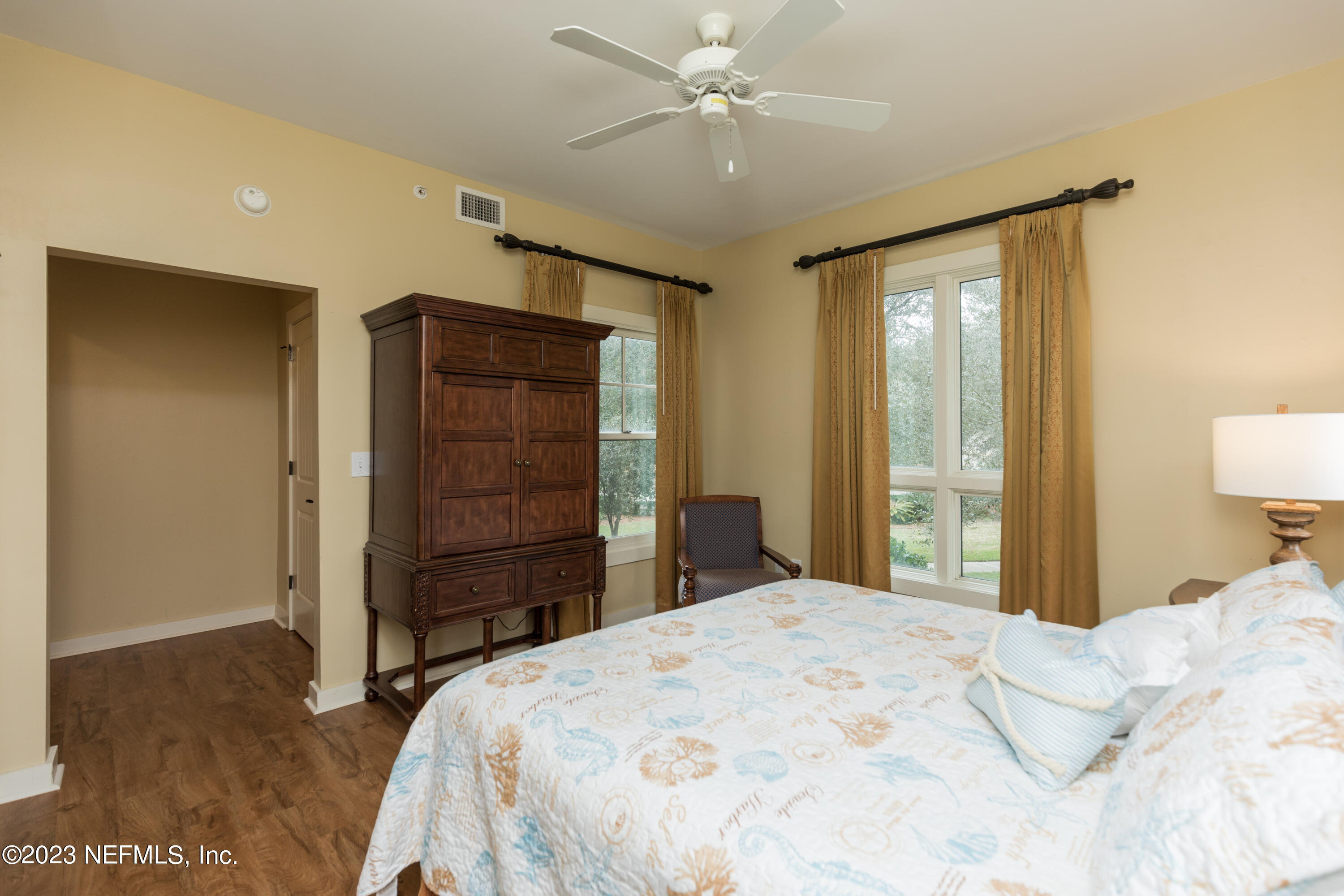945 Registry Boulevard, Unit 201 St. Augustine, FL 32092 - Photo 32 of 65 a bedroom with a bed and a dresser
