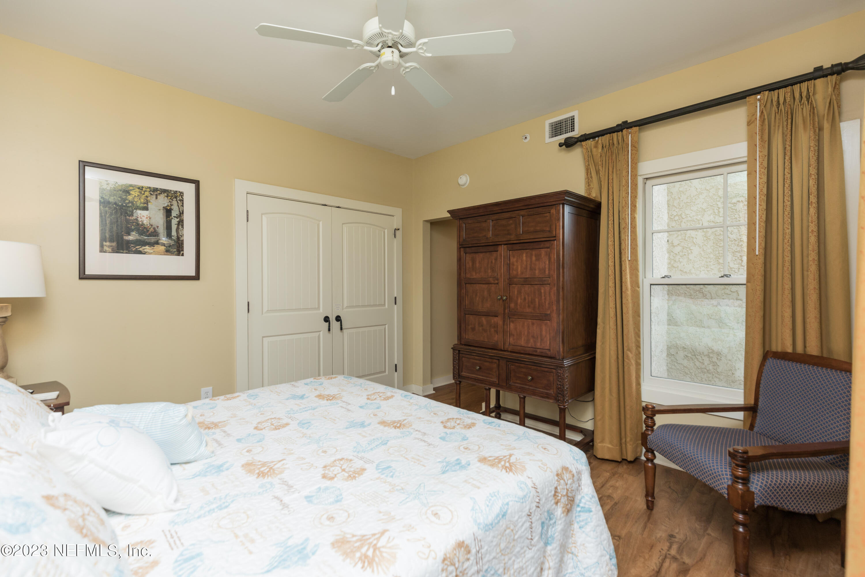 945 Registry Boulevard, Unit 201 St. Augustine, FL 32092 - Photo 35 of 65 a bedroom with a bed and a window