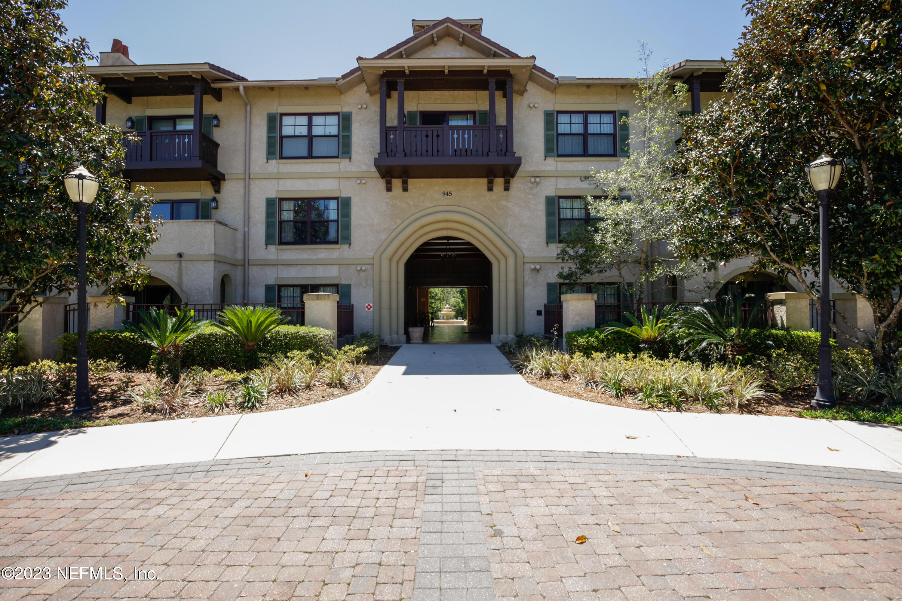 945 Registry Boulevard, Unit 201 St. Augustine, FL 32092 - Photo 63 of 65 a view of a house with a small yard and potted plants