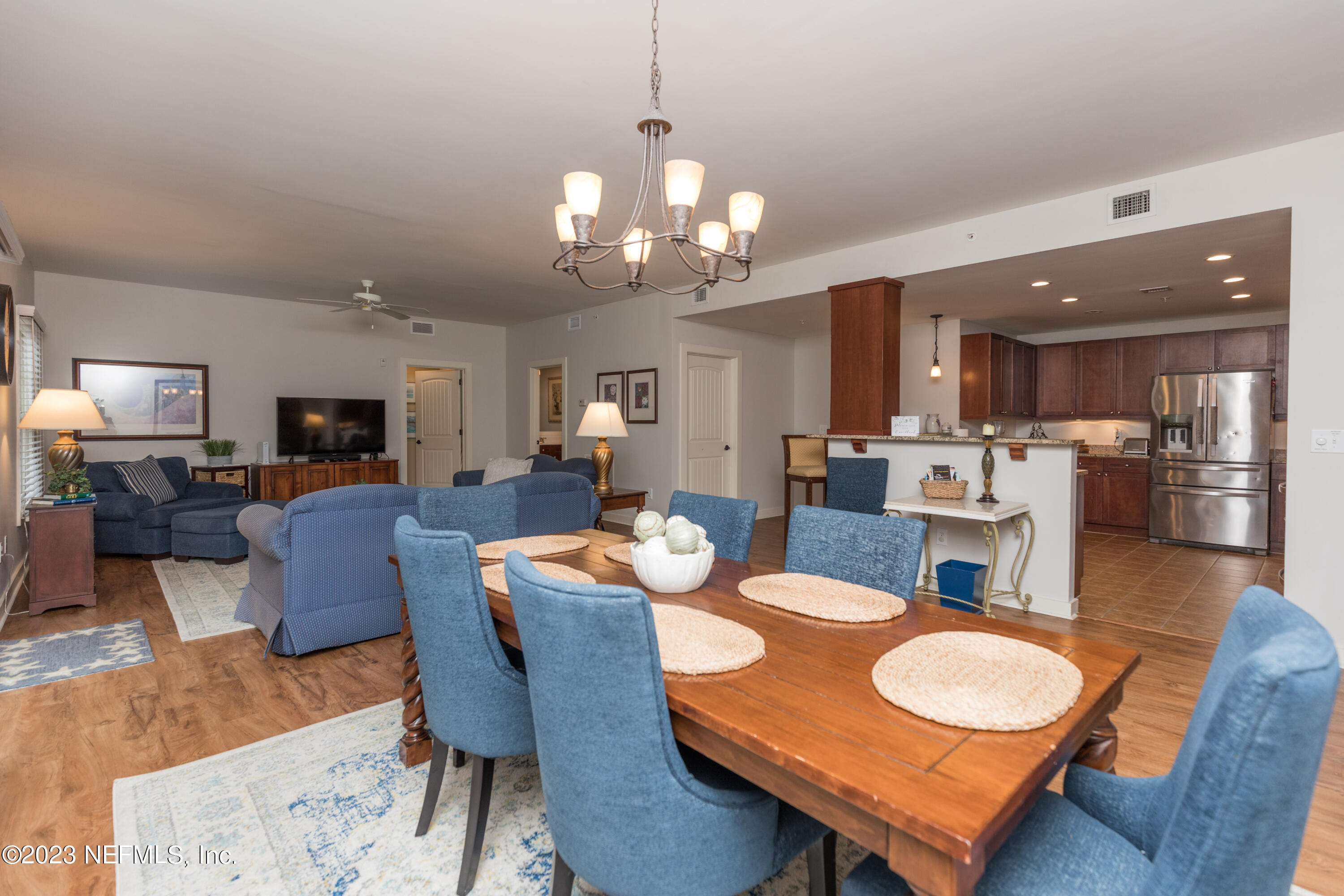 945 Registry Boulevard, Unit 201 St. Augustine, FL 32092 - Photo 6 of 65 a view of a dining room with furniture and wooden floor