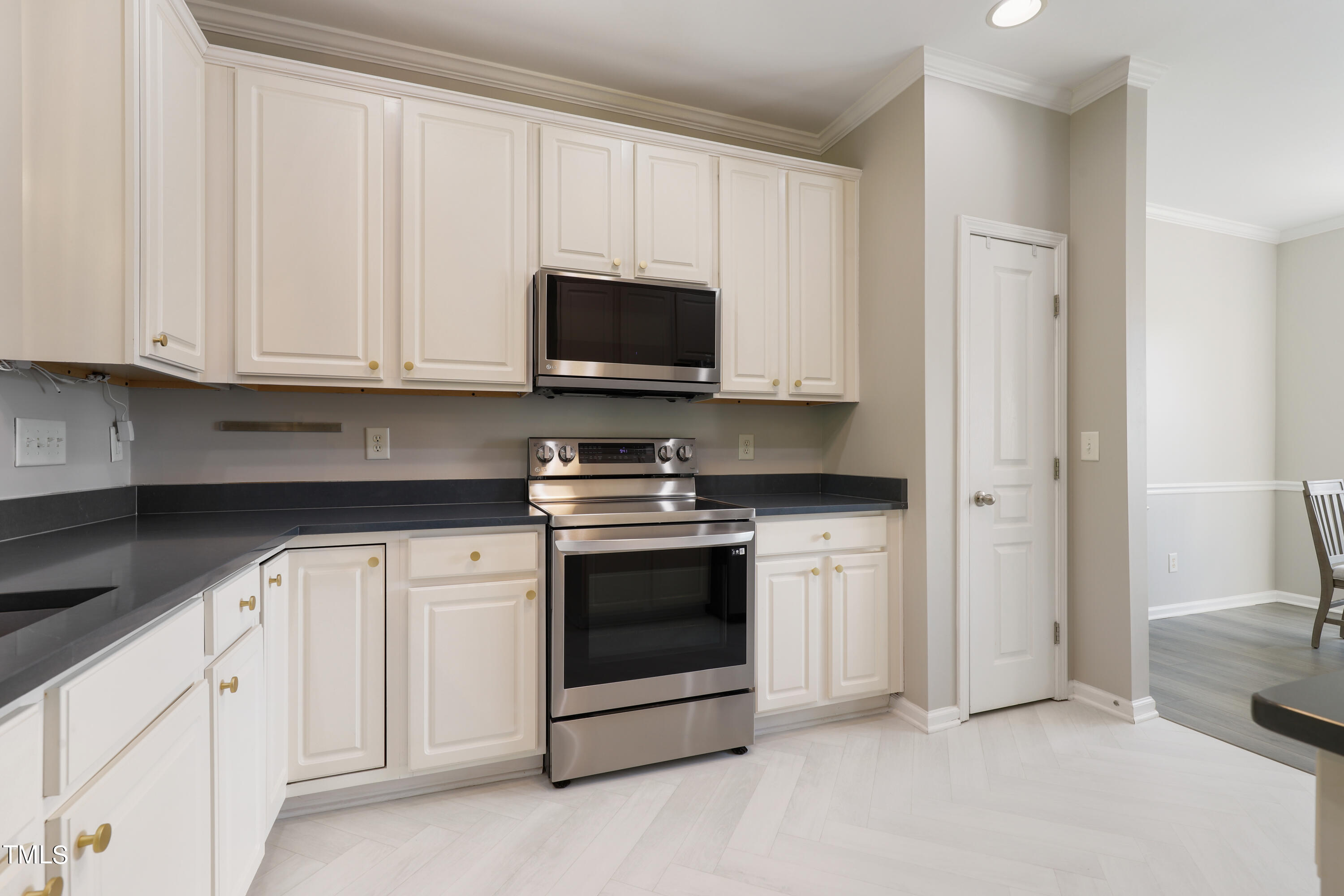 5925 Cameo Glass Way Raleigh, NC 27612 - Photo 11 of 38 Stainless appliances and gorgeous countertops and white cabinets