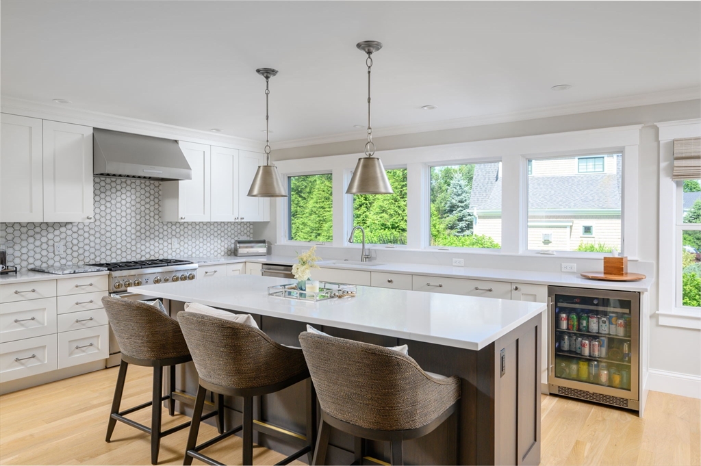 34 Highview Drive Hingham, MA 02043 - Photo 11 of 40 a kitchen with a stove a sink a table and chairs in it