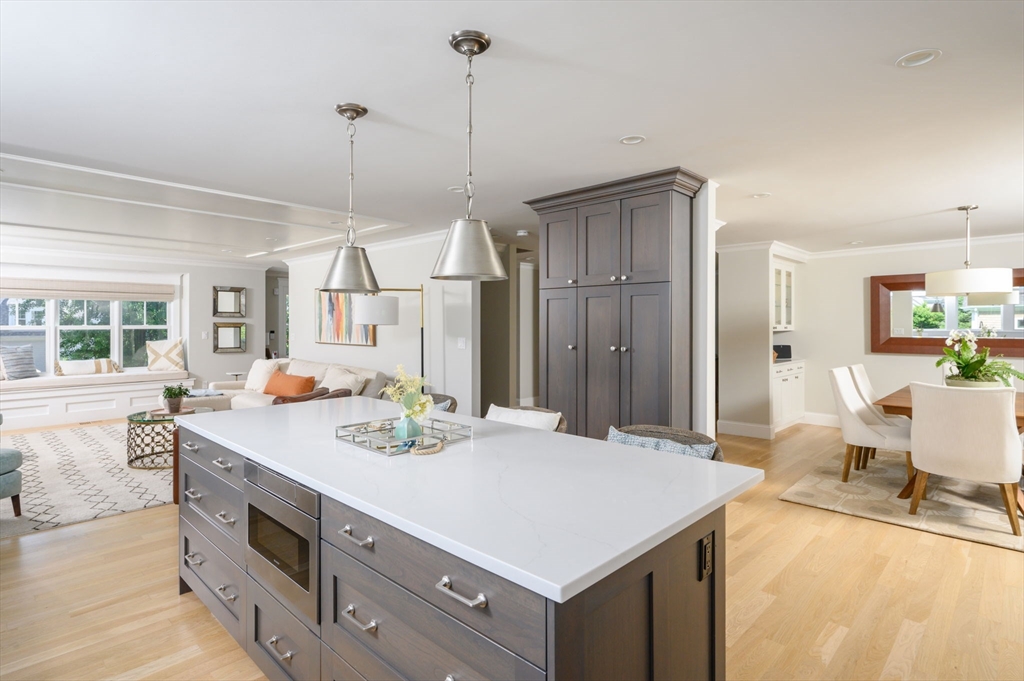 34 Highview Drive Hingham, MA 02043 - Photo 12 of 40 a kitchen with stainless steel appliances a sink a stove a refrigerator a dining table and chairs with wooden floor