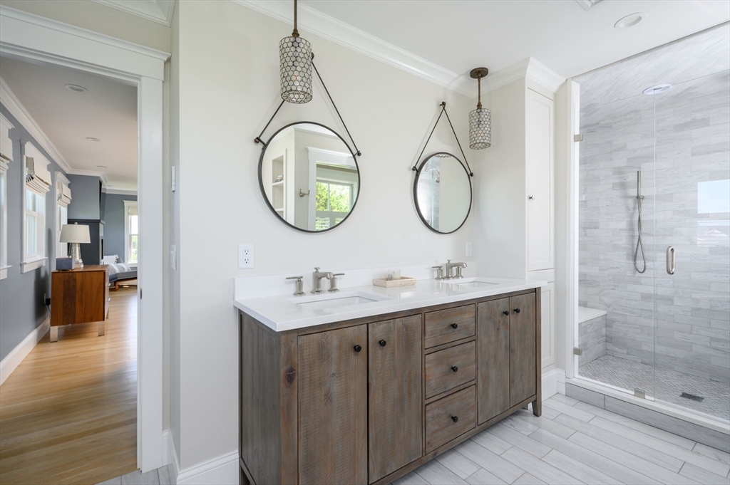 34 Highview Drive Hingham, MA 02043 - Photo 24 of 40 a bathroom with a granite countertop sink a mirror and shower