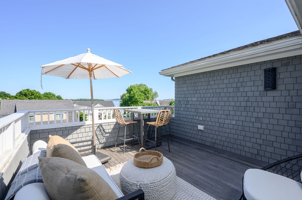 34 Highview Drive Hingham, MA 02043 - Photo 29 of 40 a view of a balcony with chairs and wooden floor