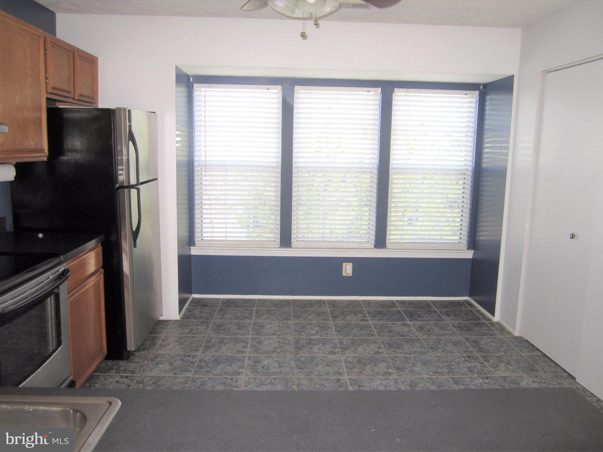 17 Bridle Lane, Unit 72 Baltimore, MD 21236 - Photo 12 of 22 a view of an empty room with a fireplace and a window