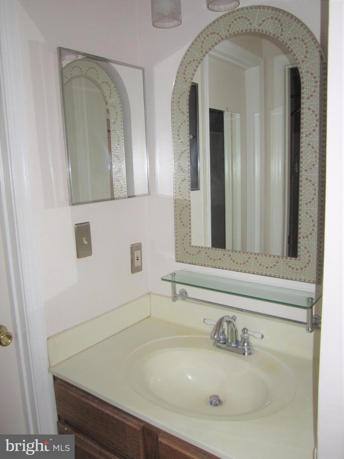 17 Bridle Lane, Unit 72 Baltimore, MD 21236 - Photo 15 of 22 a bathroom with a sink and mirror