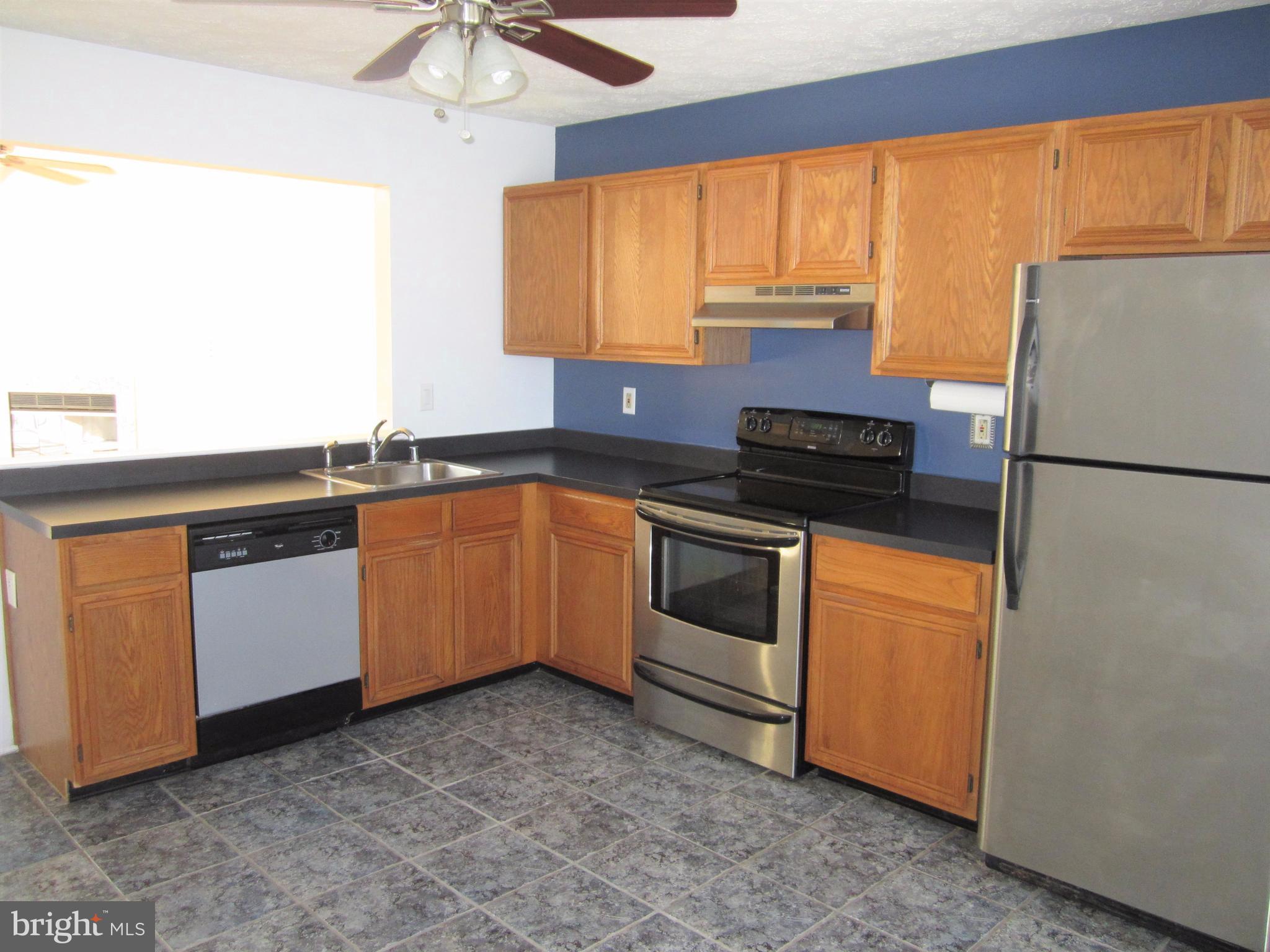 17 Bridle Lane, Unit 72 Baltimore, MD 21236 - Photo 10 of 22 a kitchen with a sink stove and refrigerator