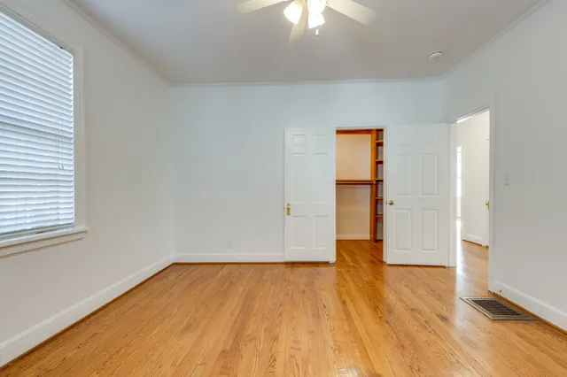 a view of a room with wooden floor and white walls