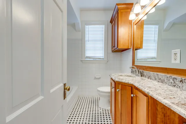 a view of a bathroom with wooden floor and a sink
