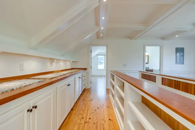 a view of empty room with wooden floor and cabinet