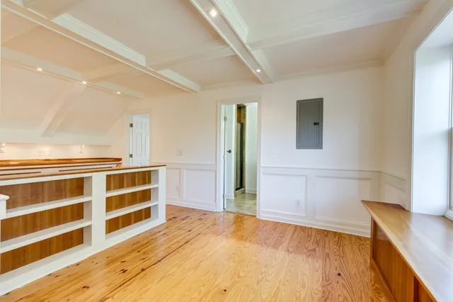 a view of empty room with window and ceiling fan