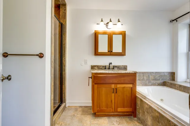 an empty room with a window and a ceiling fan
