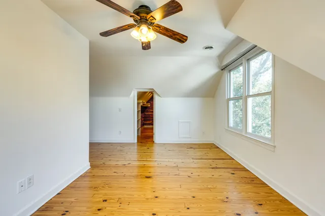 a view of a hallway with wooden floor and a fireplace