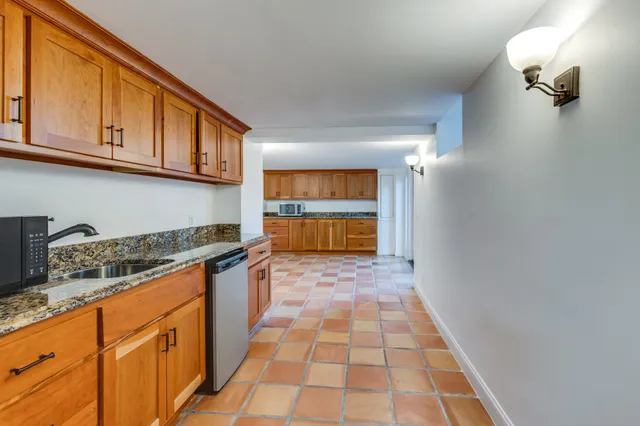a view of an empty room with a wooden floor and a window