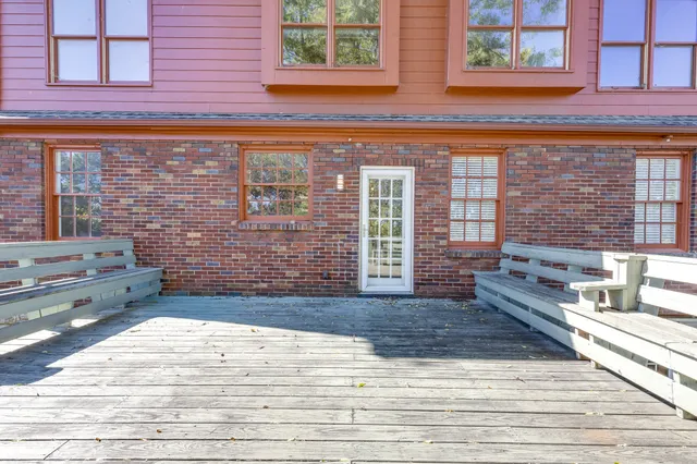 a view of a hallway with wooden floor and glass door
