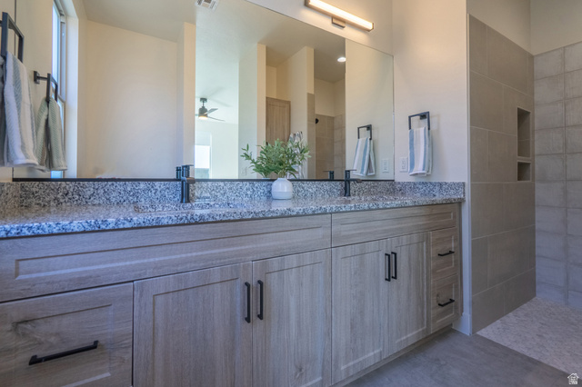 2972 West 570 North Hurricane, UT 84737 - Photo 55 of 104 Bathroom with double vanity, a tile shower, and a ceiling fan