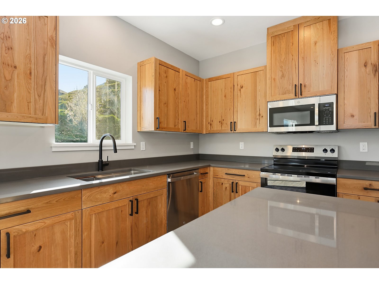 1680 Morton Street The Dalles, OR 97058 - Photo 9 of 36 a kitchen with stainless steel appliances granite countertop a stove a sink dishwasher and a microwave