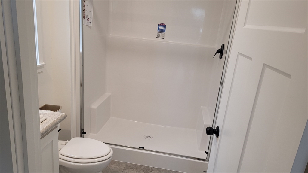 286 Newbury Street, Unit 110 Peabody, MA 01960 - Photo 15 of 15 a white toilet sitting next to a bathroom sink