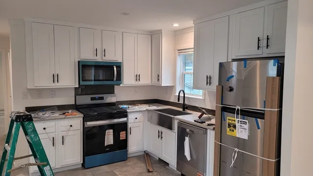 a kitchen with stainless steel appliances a refrigerator stove and microwave
