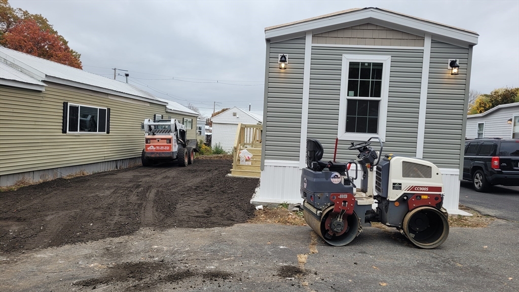 286 Newbury Street, Unit 110 Peabody, MA 01960 - Photo 7 of 15 a blue house with trees in front of it