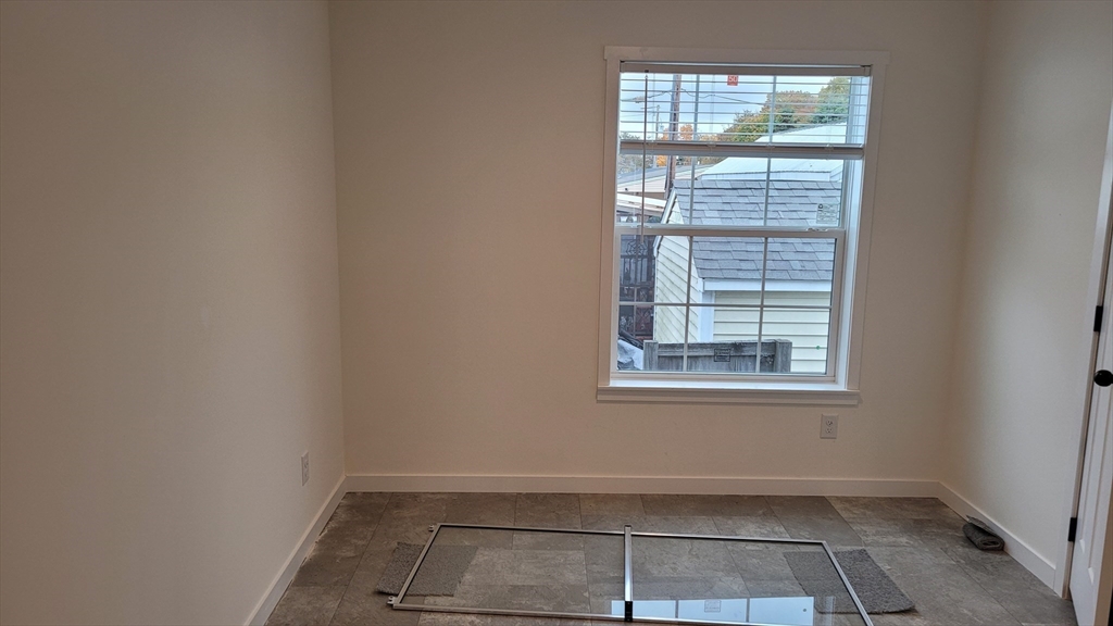 286 Newbury Street, Unit 110 Peabody, MA 01960 - Photo 9 of 15 an empty room with a window