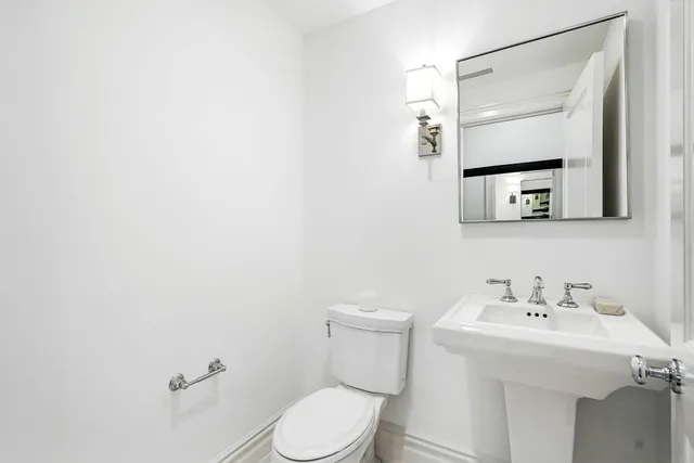 a kitchen with stainless steel appliances granite countertop a table chairs sink refrigerator and cabinets