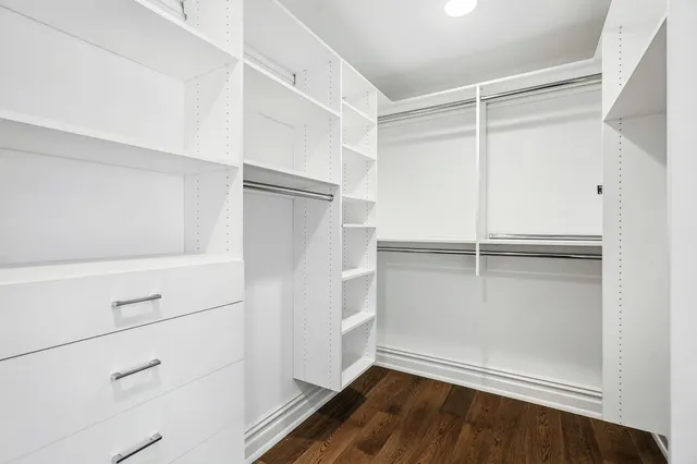 a bathroom with a tub a sink and mirror