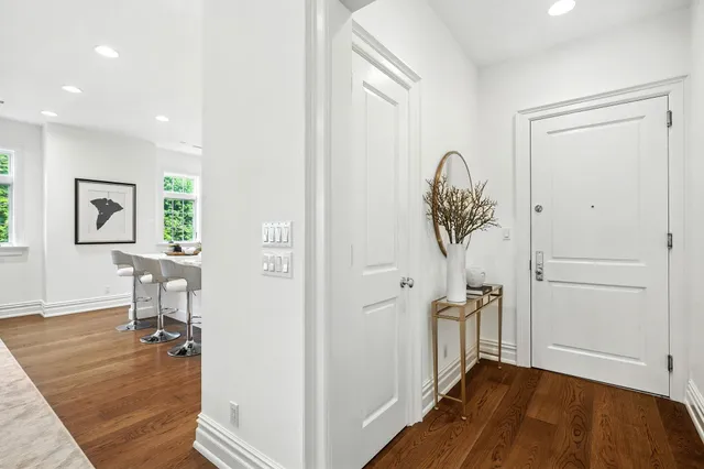 wooden floor in a hall with a cabinet and a rug