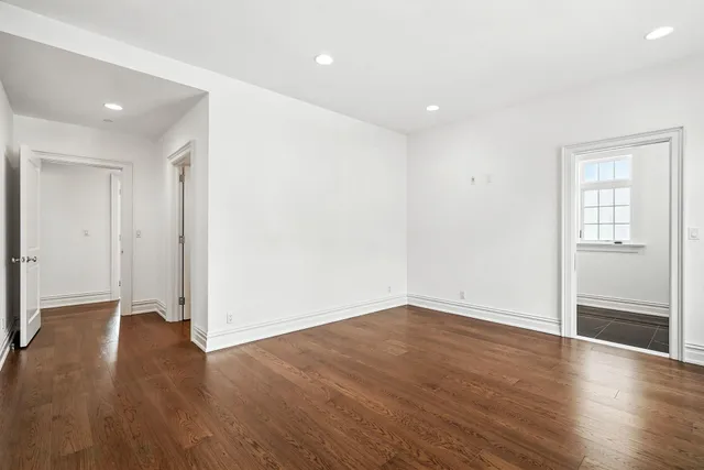 a view of walk in closet with empty racks