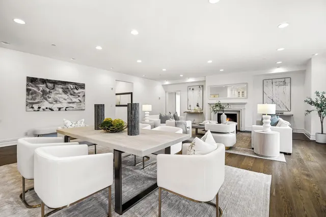 a living room with furniture a fireplace and a table